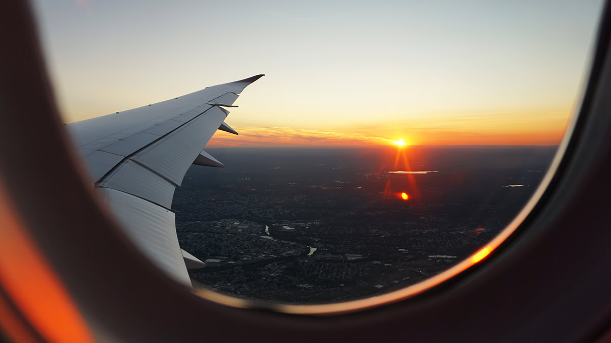 photo of sunset taken through airplane window