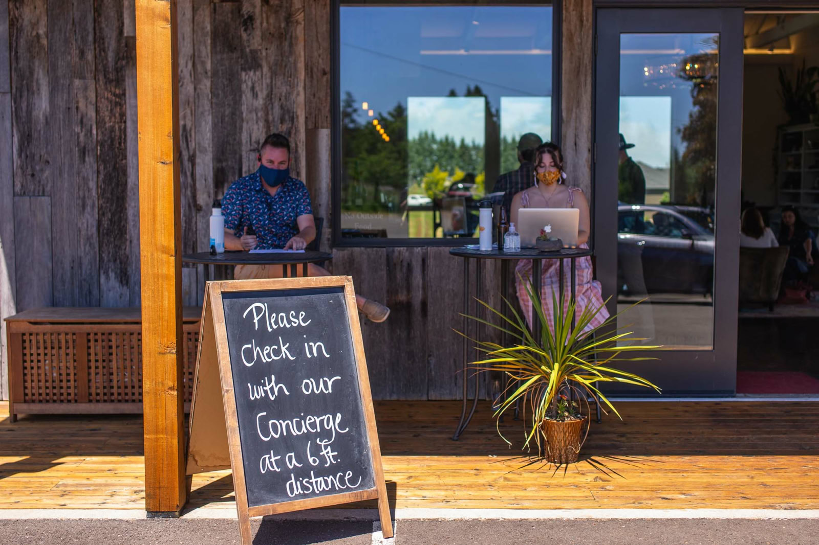 A photograph of the entrance to Brooks Wine's tasting room, with guests wearing face masks