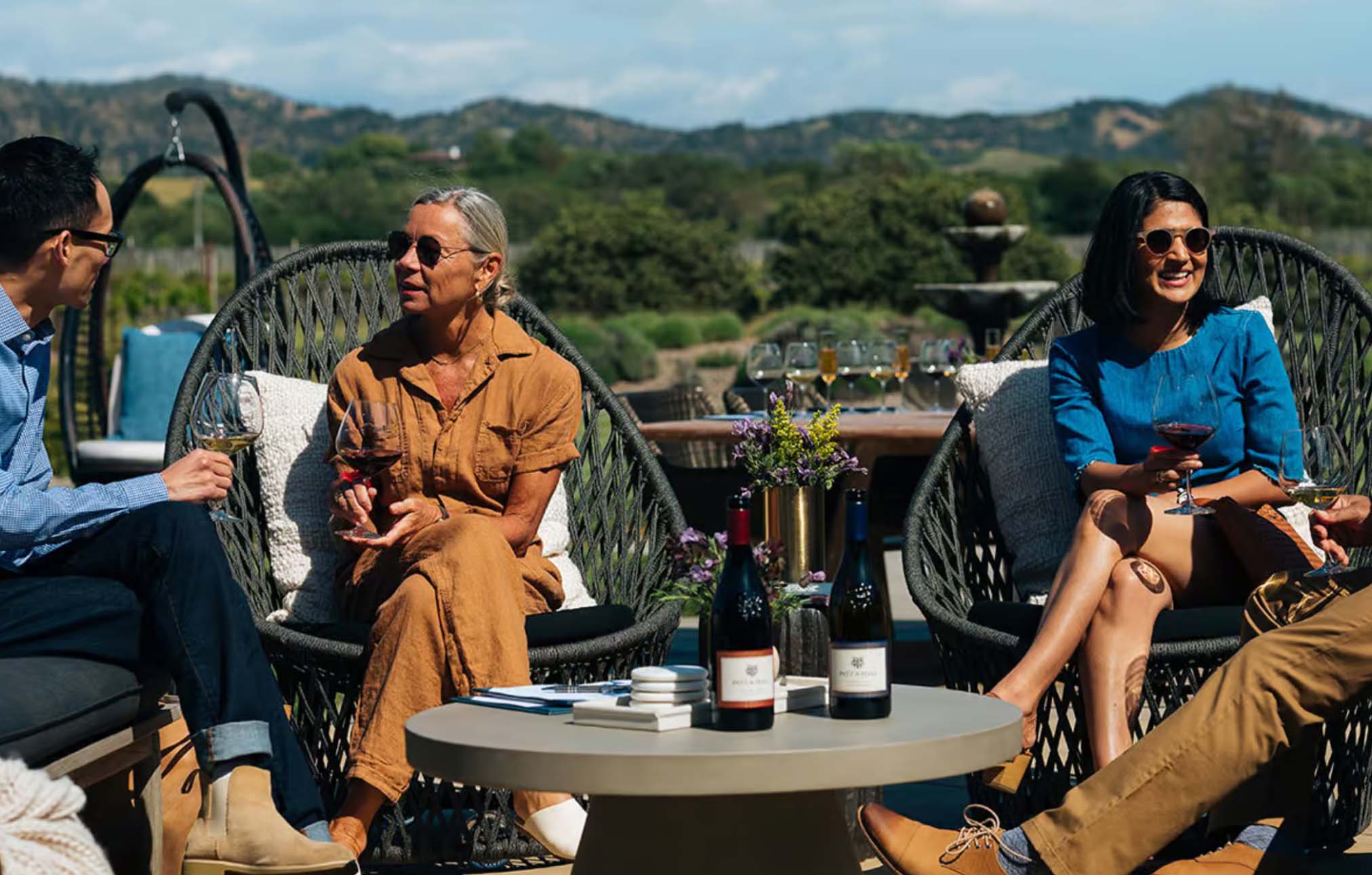 Two men and two women sitting outdoors at Patz and Hall drinking wine