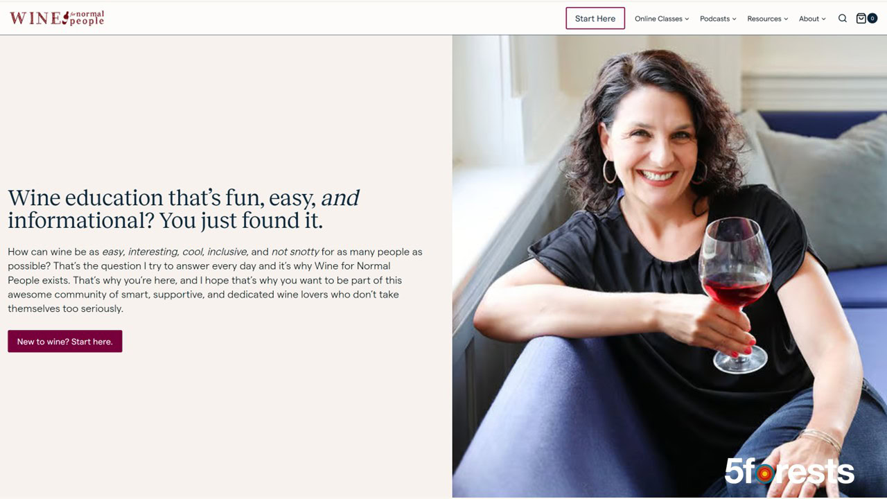 A smiling woman with dark hair sits on a sofa holding a glass of red wine. She wears a black top and gold earrings. The text beside her reads, "Wine education that's fun, easy, and informational? You just found it.