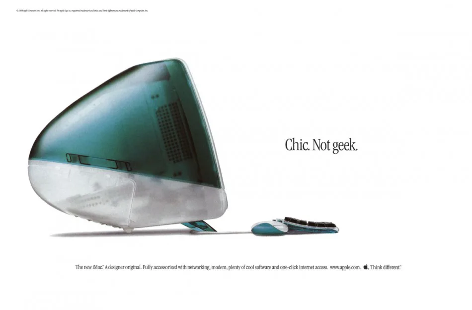 A translucent teal Apple iMac G3 computer with matching keyboard and mouse on a white background. The text reads, “Chic. Not geek.” with a description of the iMac and the slogan “Think different.”.
