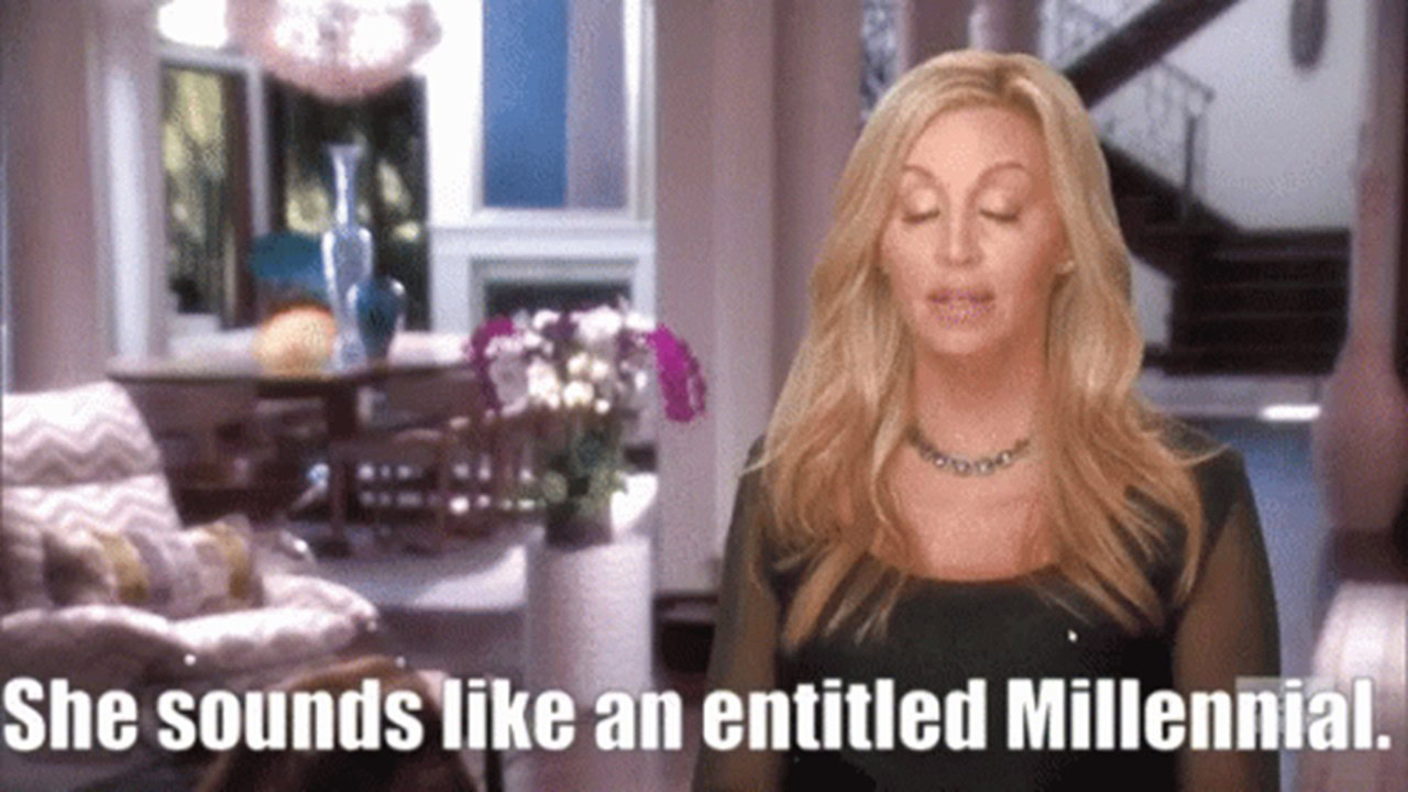 A woman with long blonde hair talks with eyes closed in a stylish living room. Text at the bottom reads, "She sounds like an entitled Millennial.