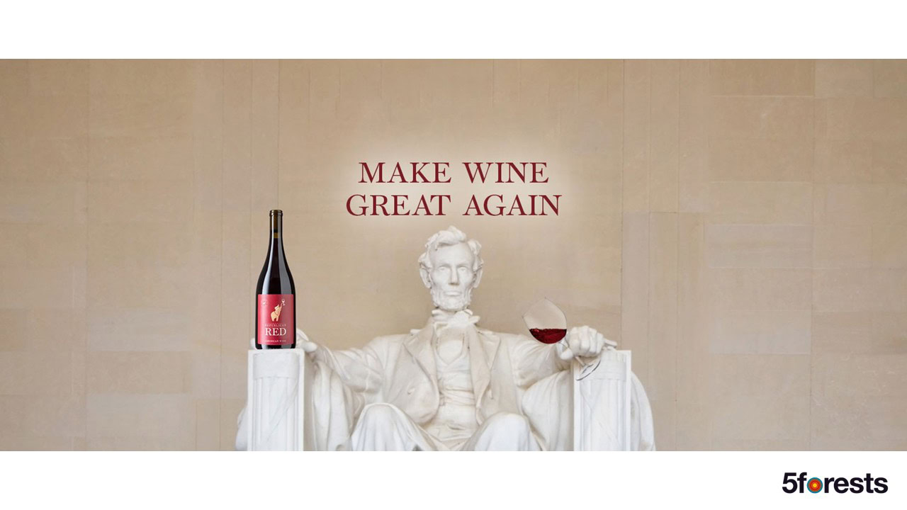 A statue of Abraham Lincoln holding a wine glass with red wine and a wine bottle beside him. Above, text reads "MAKE WINE GREAT AGAIN." 