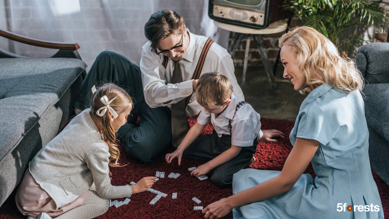 1950s family sitting on the floor playing dominos