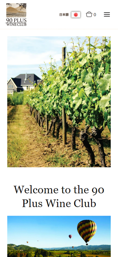 The 90 Plus Wine Club homepage on a phone, with the vine rows photograph above the heading "Welcome to the 90 Plus Wine Club" and the balloons over the valley below.
