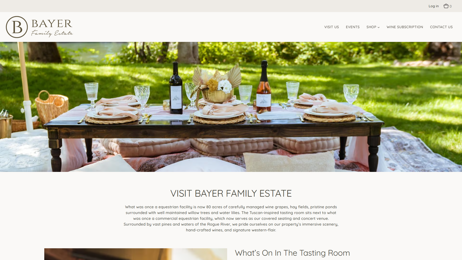 The Bayer Family Estate Visit Us page in a desktop browser, headed "Visit Bayer Family Estate", with a long table laid for a meal outdoors under trees, and a section headed "What's On In The Tasting Room".