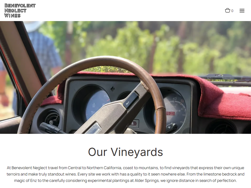 The Benevolent Neglect vineyards page in a desktop browser, with a view through the windshield of a vintage car onto the vines, above the heading "Our Vineyards".