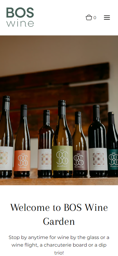 The Bos Wine homepage on a phone, with the row of labeled bottles above the welcome to the wine garden.