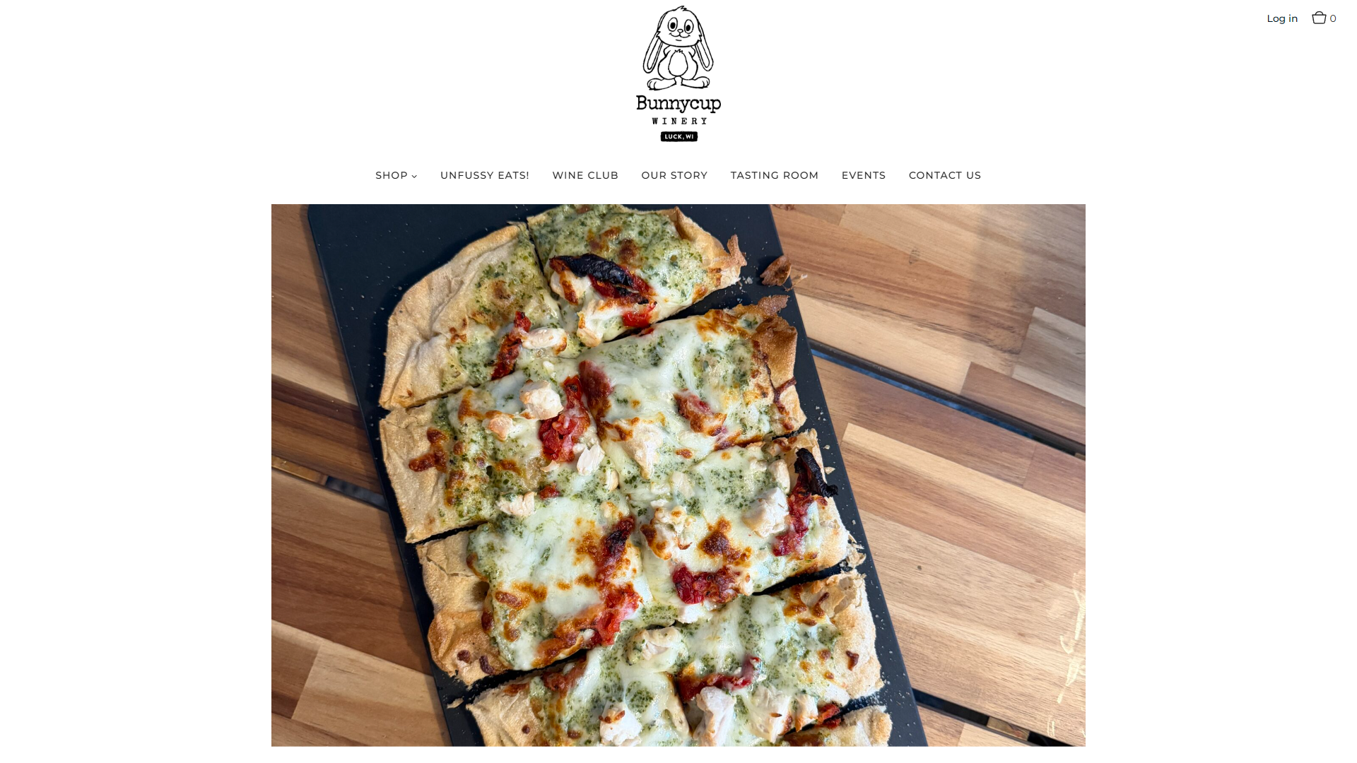 The Bunnycup food page in a desktop browser, with a flatbread pizza photographed from above on a wooden counter.