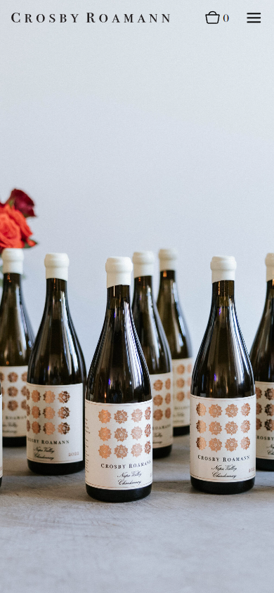 The Crosby Roamann membership page on a phone, with the row of bottles and roses.
