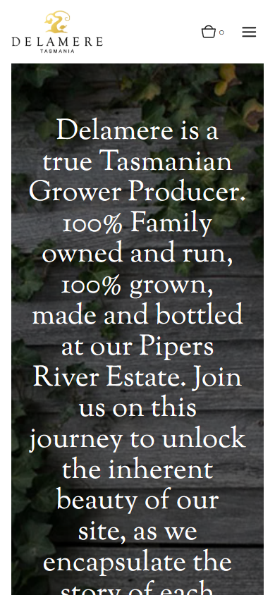 The Delamere homepage on a phone, with the grower producer statement set over the ivy-covered timber wall.