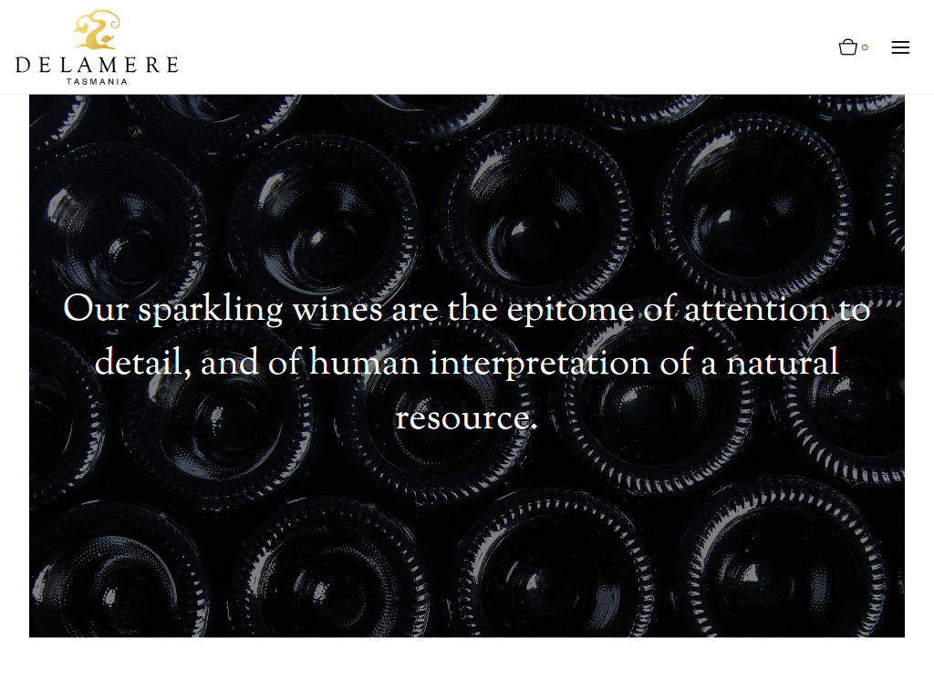 The Delamere philosophy page in a desktop browser, with a close view of riddled sparkling bottle bases behind a statement about attention to detail in the sparkling wines.