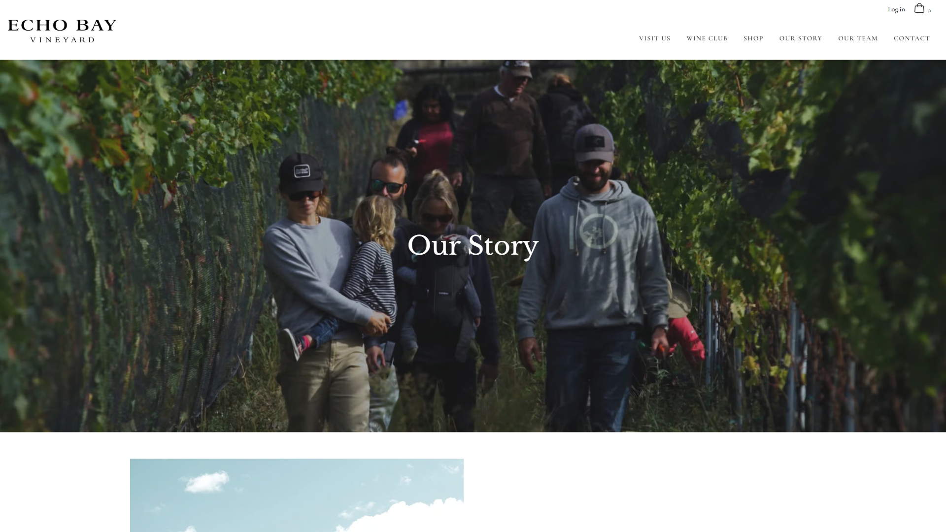 The Echo Bay story page in a desktop browser, headed "Our Story" over a group of adults and children walking out of the vine rows at harvest.