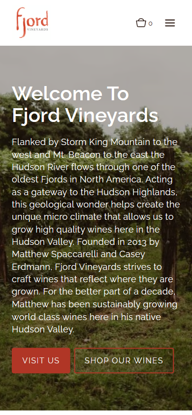 The Fjord Vineyards homepage on a phone, with the welcome heading and introduction over the vineyard photograph and the visit and shop buttons.