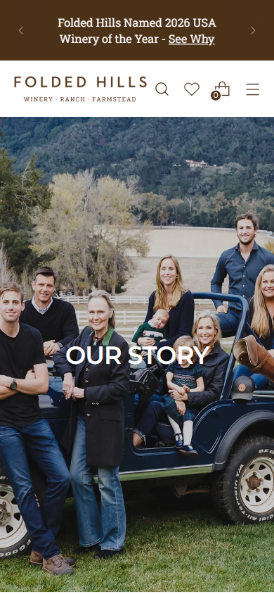 The Folded Hills story page on a phone, headed "Our Story", with the family group photograph around the vehicle.