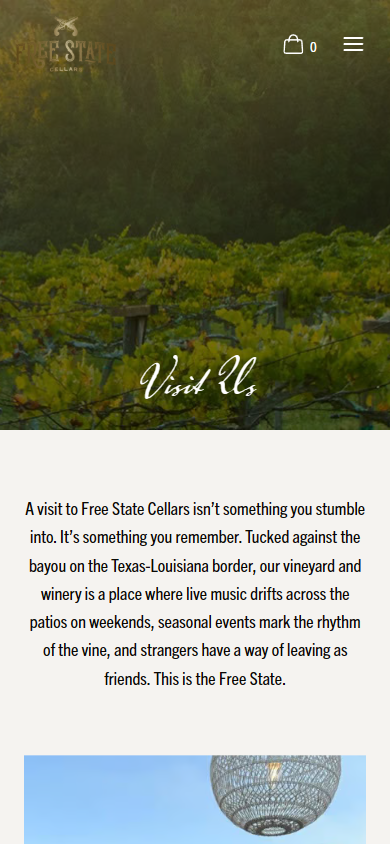 The Free State Cellars Visit Us page on a phone, headed "Visit Us" over the vineyard, with the invitation to visit below.