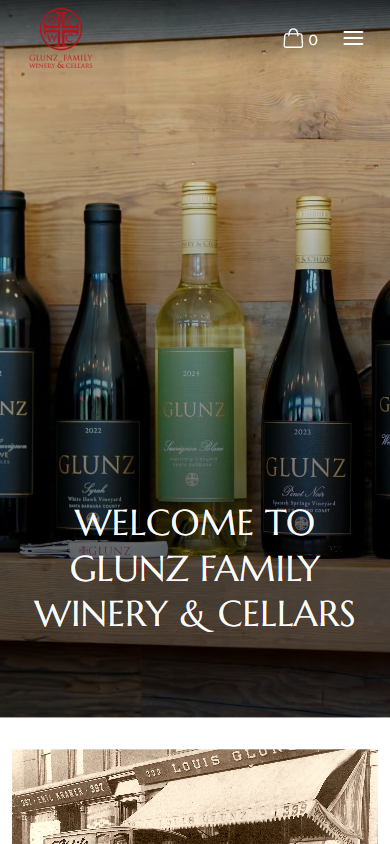 The Glunz homepage on a phone, with the bottles on the shelf above the welcome heading.