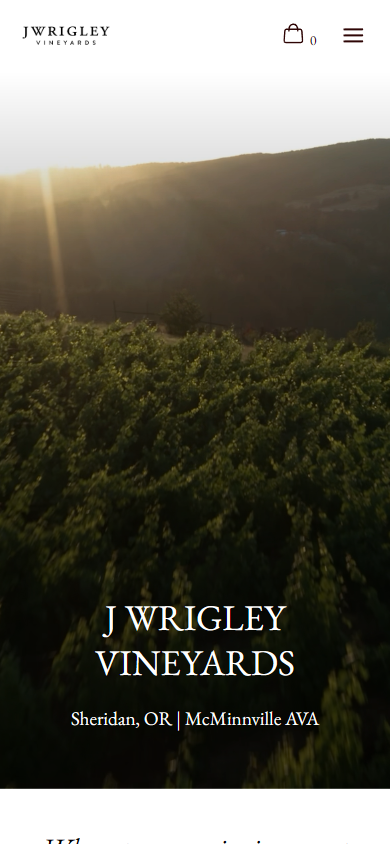 The J Wrigley homepage on a phone, with the dawn hills behind the winery name and the McMinnville AVA line.