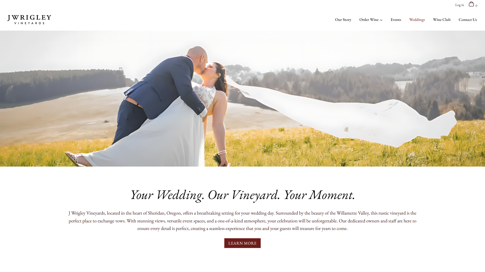 The J Wrigley weddings page in a desktop browser, with a couple kissing in a meadow and the bride's veil streaming out behind them, above the line "Your Wedding. Our Vineyard. Your Moment."