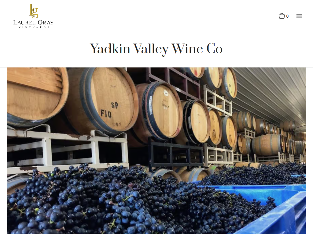 The Laurel Gray page for Yadkin Valley Wine Co in a desktop browser, with racked barrels above blue bins of freshly picked dark grapes.