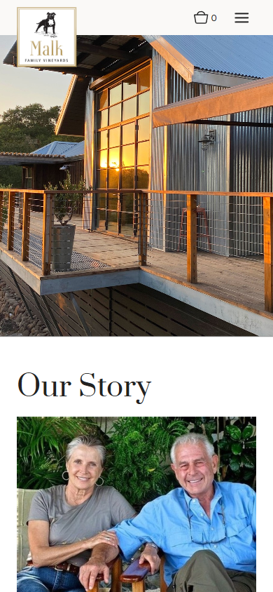 The Malk Family story page on a phone, with the timber winery building above the heading "Our Story" and a photograph of the owners.
