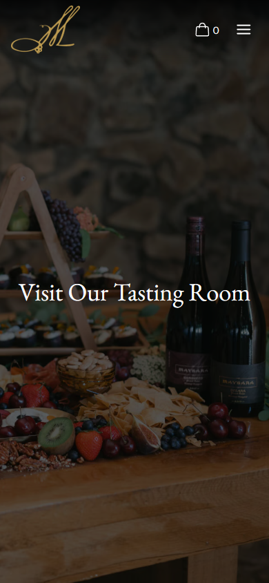 The Maysara Visit Us page on a phone, headed "Visit Our Tasting Room" over the laden table and bottles.