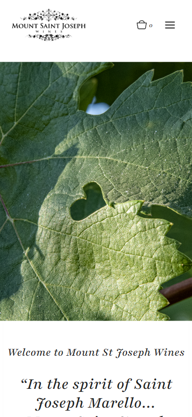 The Mount Saint Joseph homepage on a phone, with the backlit grape leaf above the welcome heading and quotation.