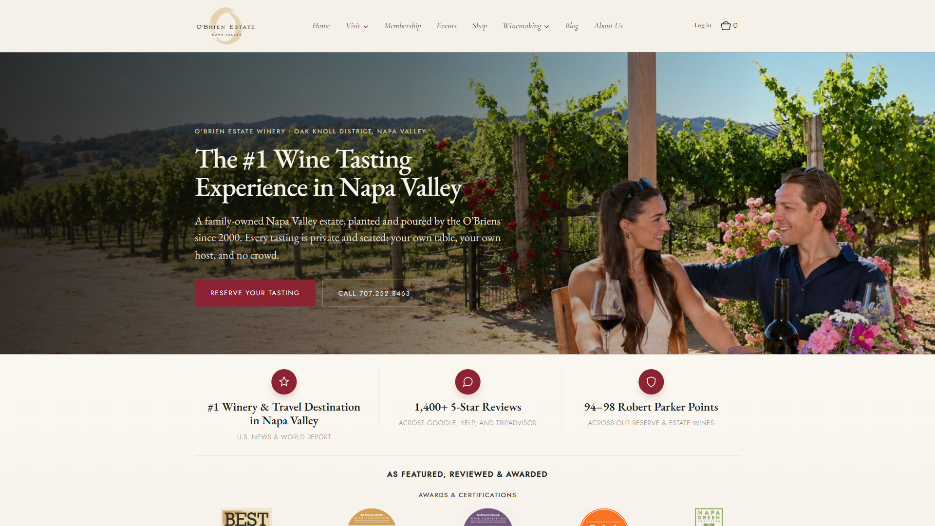 The O'Brien Estate visit page in a desktop browser, with a couple seated among the vines and roses holding glasses of red, beside the claim to be the number one wine tasting experience in Napa Valley, above review and scoring statistics.