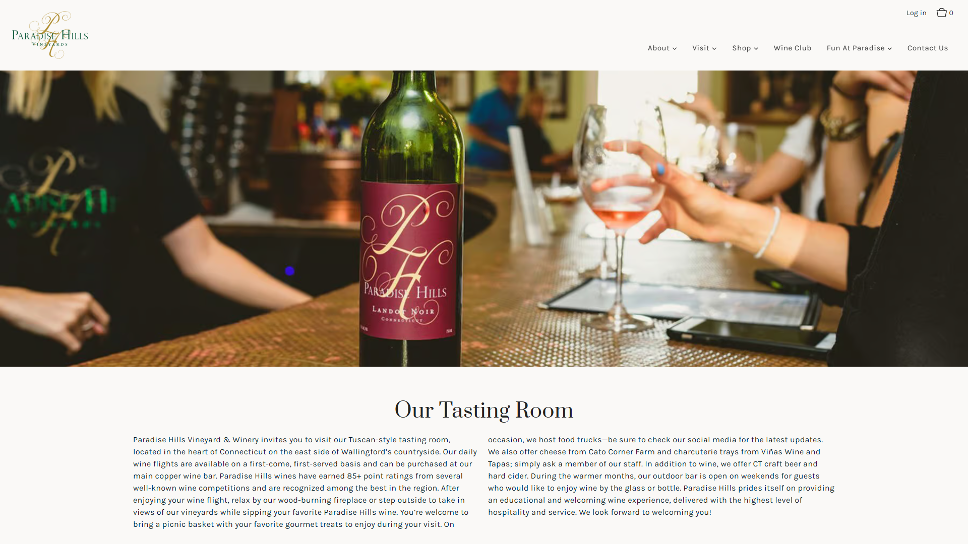The Paradise Hills tasting room page in a desktop browser, with a bottle standing on the bar as a guest holds a glass of rosé, above the heading "Our Tasting Room" and a description of the Tuscan-style room.