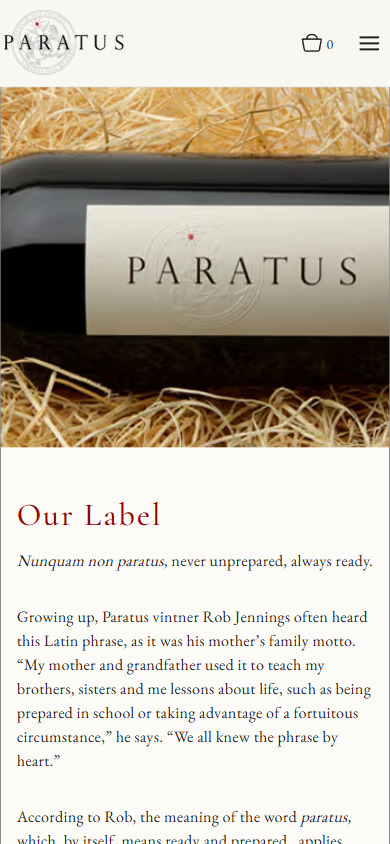 The Paratus label page on a phone, with the bottle on straw above the heading "Our Label" and the family motto.