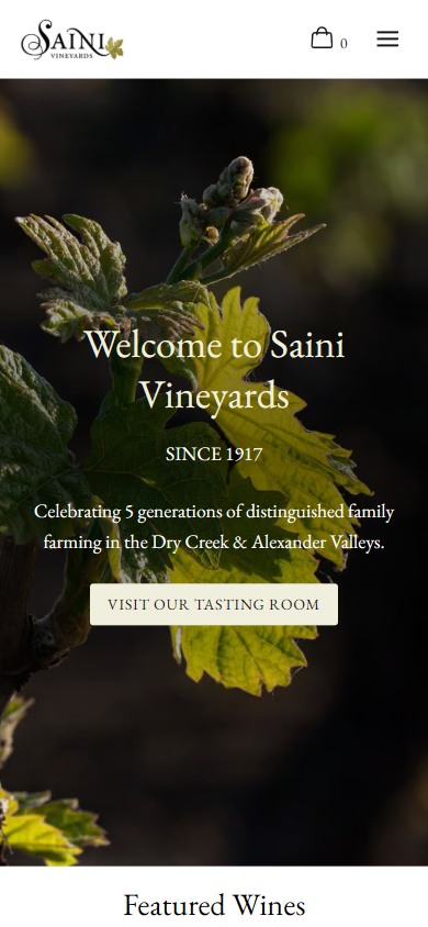 The Saini homepage on a phone, with the vine shoot behind the welcome heading and the five generations line, above the featured wines.