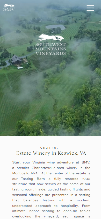The Southwest Mountains homepage on a phone, with the misted aerial view and logo above an invitation to visit the estate winery in Keswick.