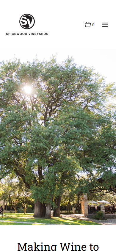 The Spicewood Vineyards homepage on a phone, with the oak tree and lawn photograph above the heading "Making Wine to Celebrate Life".