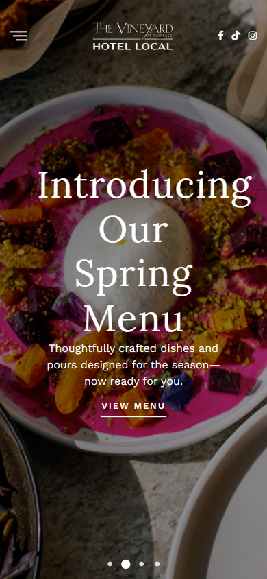 The Vineyard at Florence homepage on a phone, with the spring menu dish behind the heading and a view menu button.