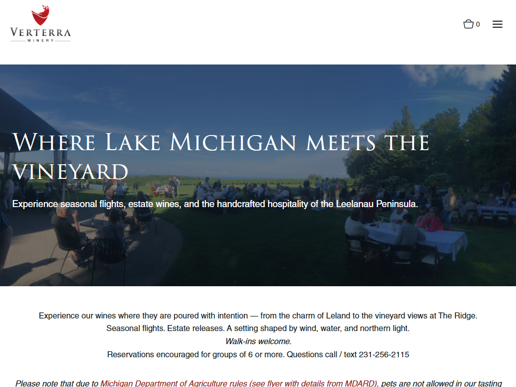 The Verterra Visit Us page in a desktop browser, headed "Where Lake Michigan meets the vineyard" over a busy terrace above the water, with the tasting options below.