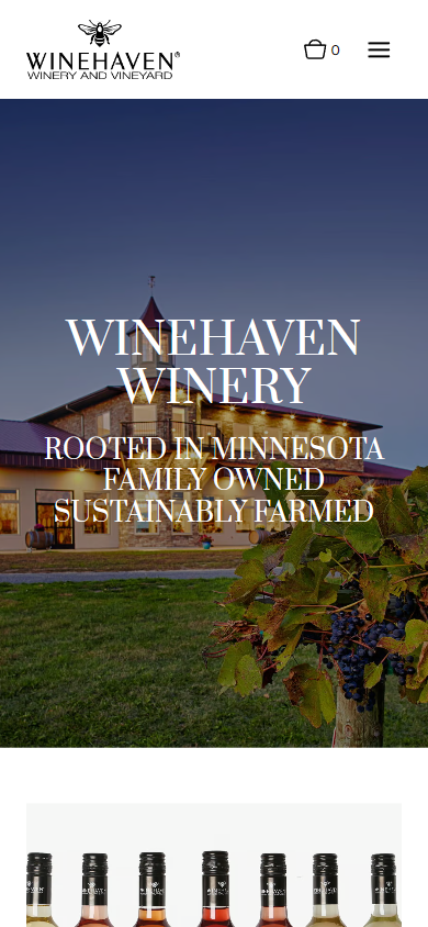 The Winehaven homepage on a phone, with the winery at dusk and the Minnesota family-owned lines above a row of bottles.