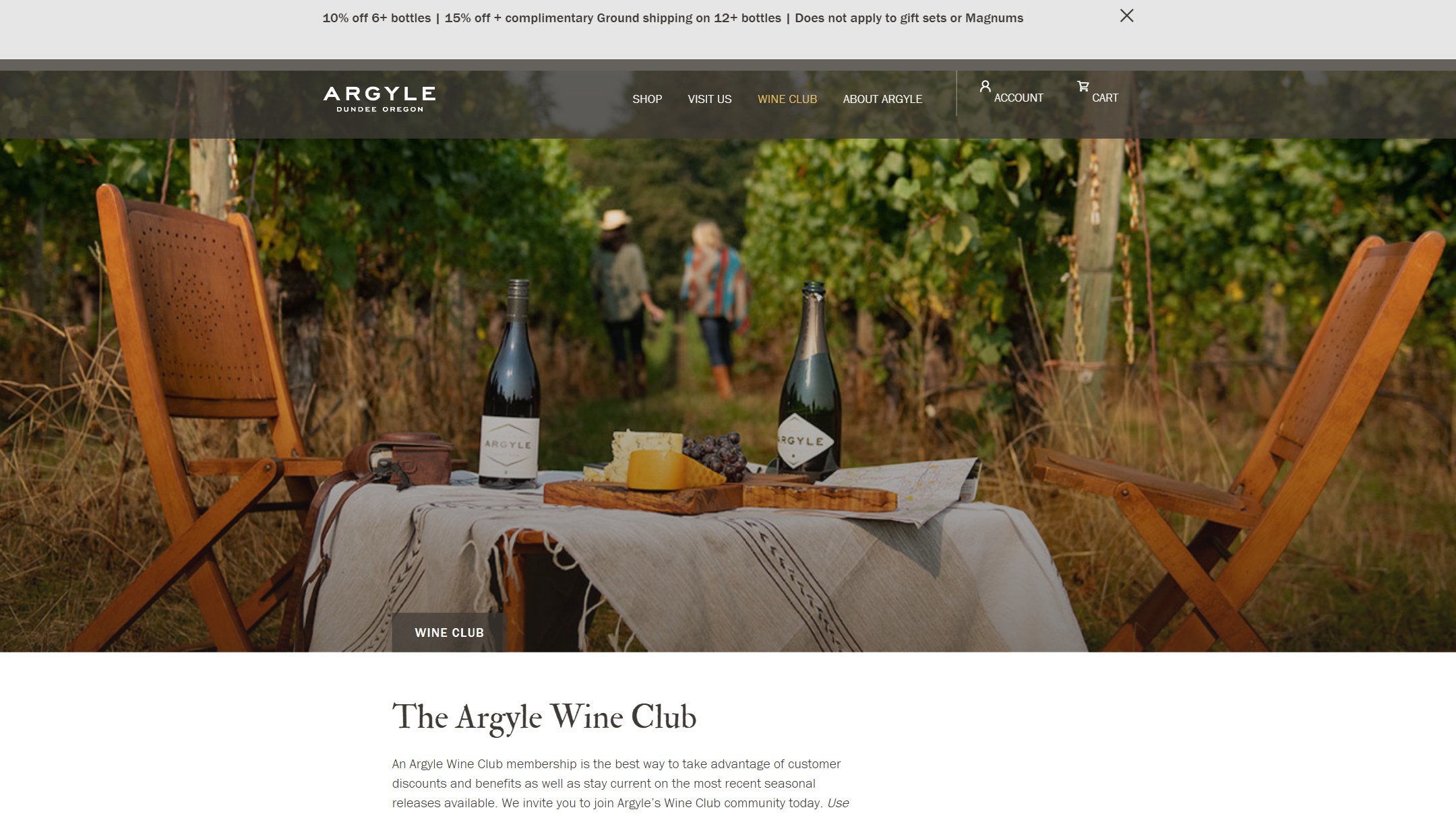 The Argyle wine club page in 2024: a picnic table with two bottles in the vineyard
