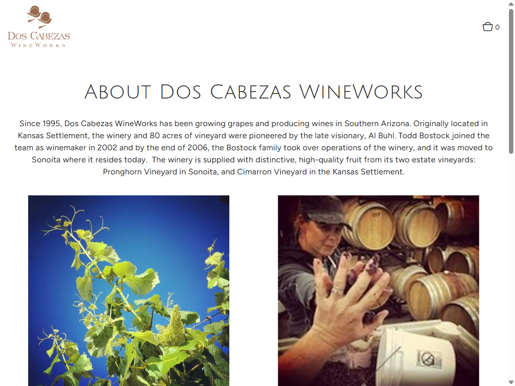 The About Dos Cabezas WineWorks page on a tablet: the winery's history since 1995, above photographs of vine leaves against the sky and a winemaker working at a barrel.