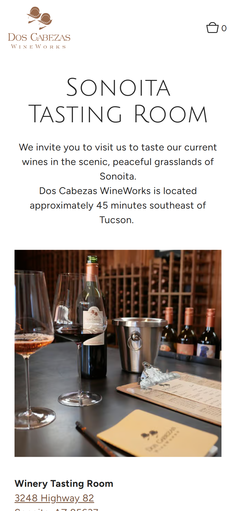 The Sonoita Tasting Room page on a phone, inviting visitors to the grasslands of Sonoita, above a photograph of the tasting bar.