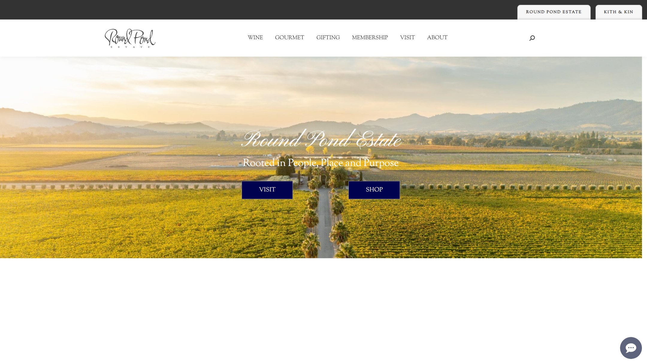 The Round Pond home page in June 2025: an aerial vineyard photograph with Visit and Shop buttons
