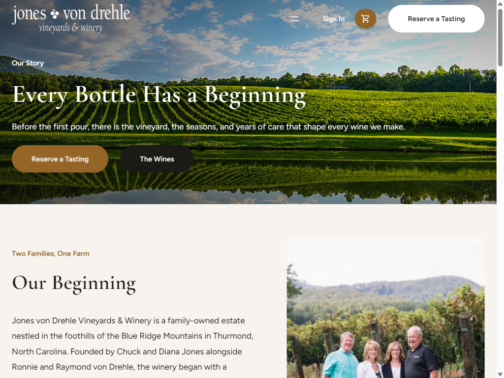 The Our Story page on a tablet: vine rows reflected in a pond under "Every Bottle Has a Beginning", above "Our Beginning" and a photograph of the two founding families in the vineyard.