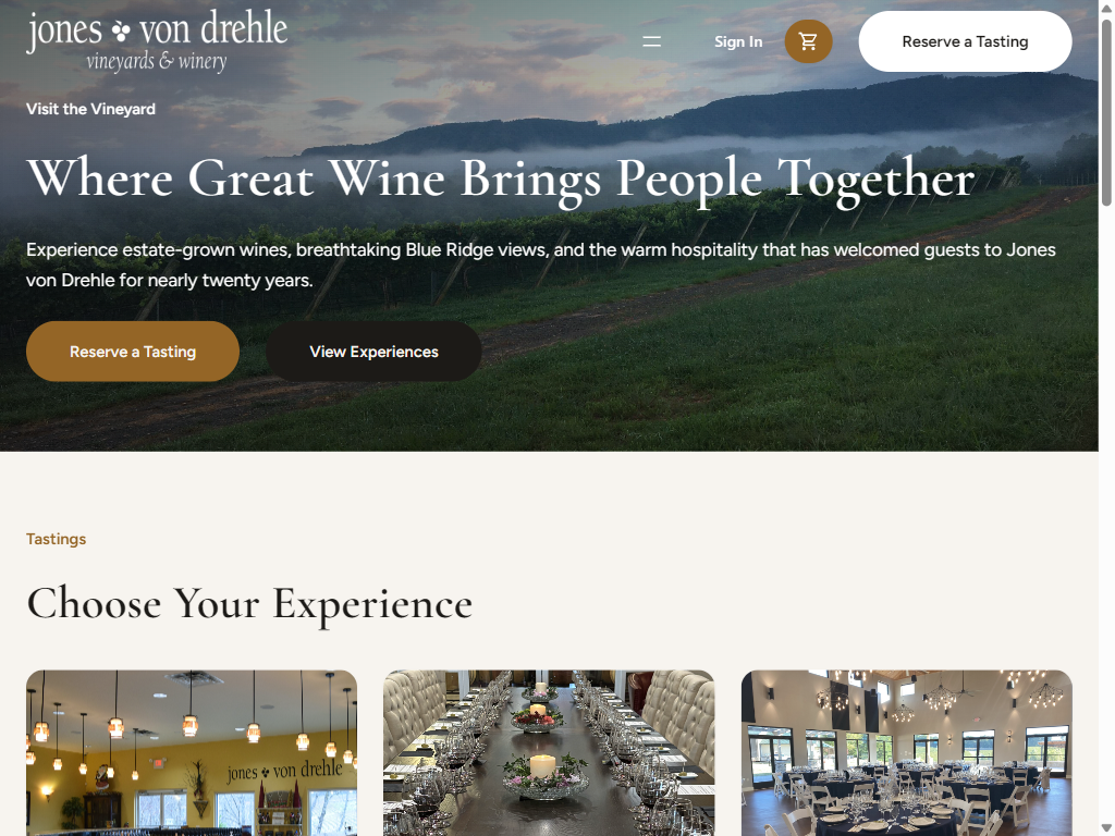 The Visit page on a tablet: misty Blue Ridge views over the vineyard under "Where Great Wine Brings People Together", above a Choose Your Experience row of tasting rooms.