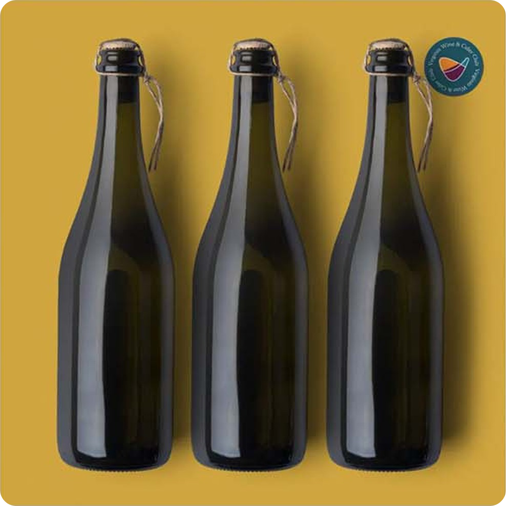 Three cider bottles on the cider club’s gold